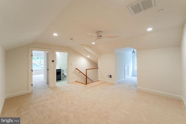 additional living space featuring lofted ceiling, ceiling fan, and light colored carpet