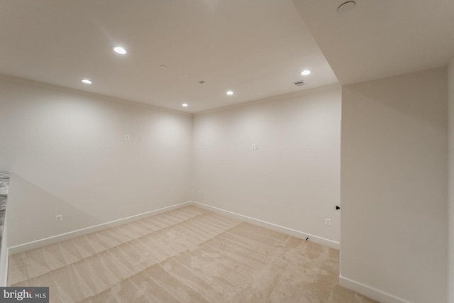 empty room with light carpet and crown molding