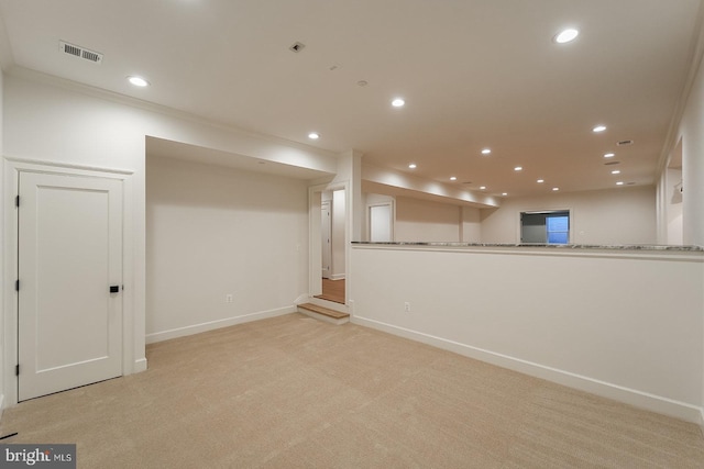 basement featuring ornamental molding and light carpet