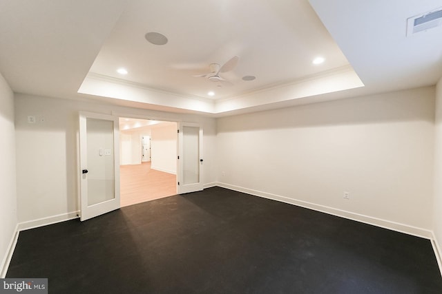 unfurnished room with ceiling fan, a tray ceiling, and ornamental molding