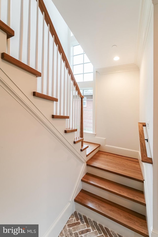 staircase featuring ornamental molding