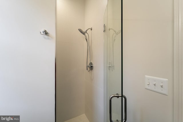 bathroom with a shower with door