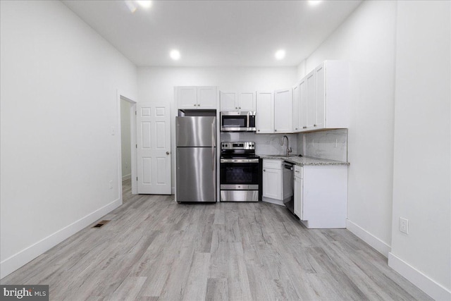 kitchen featuring white cabinets, stainless steel appliances, and sink