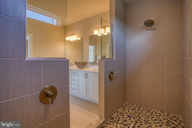 bathroom with vanity, tile patterned flooring, and tiled shower