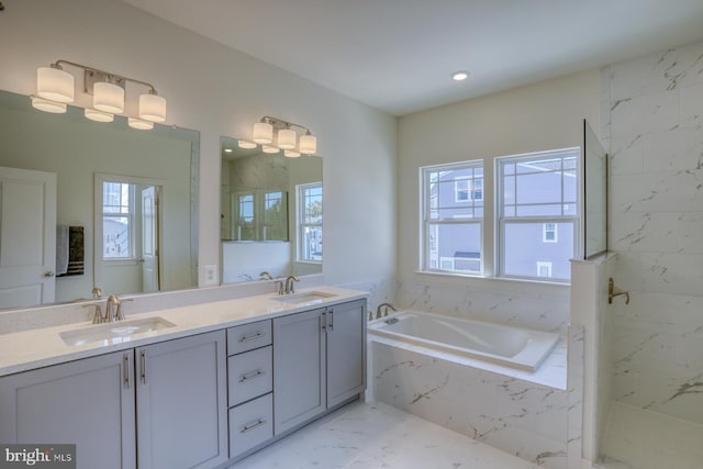 bathroom with vanity, independent shower and bath, and plenty of natural light