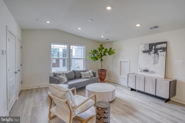 living room with lofted ceiling and light wood-type flooring