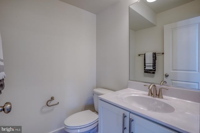 bathroom featuring toilet and vanity