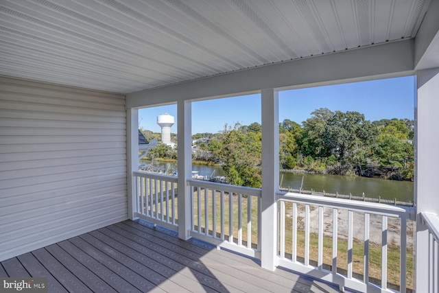 unfurnished sunroom featuring a water view