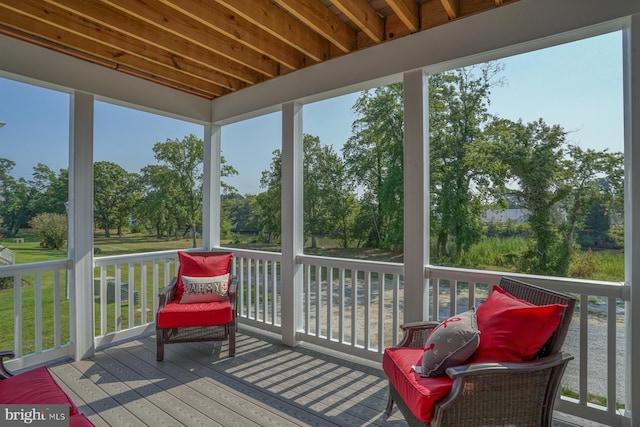 sunroom with beamed ceiling and plenty of natural light