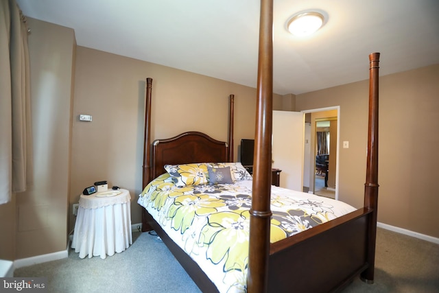 carpeted bedroom featuring baseboards