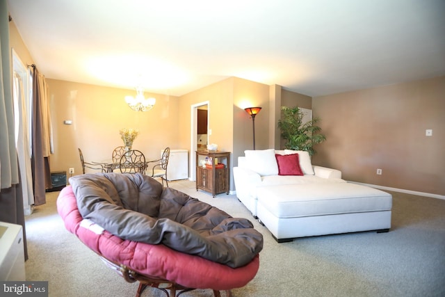 living room with carpet, a notable chandelier, and baseboards