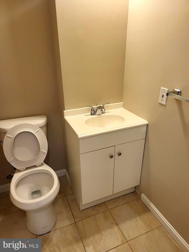 bathroom with vanity, tile patterned floors, and toilet