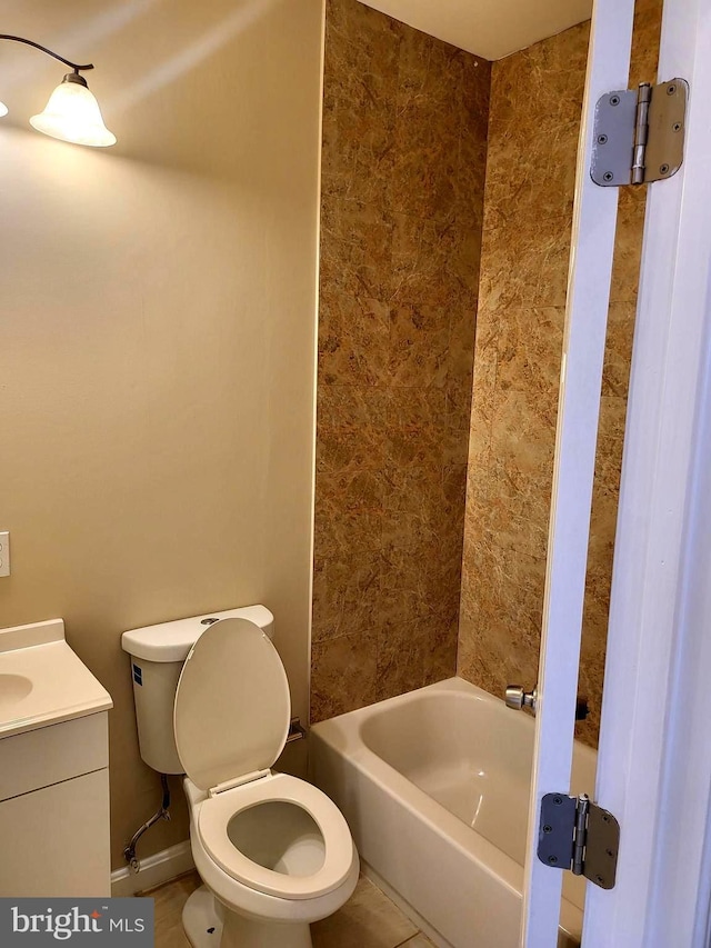 bathroom with tile patterned flooring, vanity, and toilet