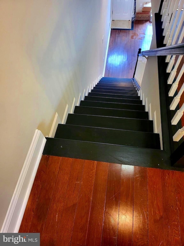 stairs with hardwood / wood-style floors