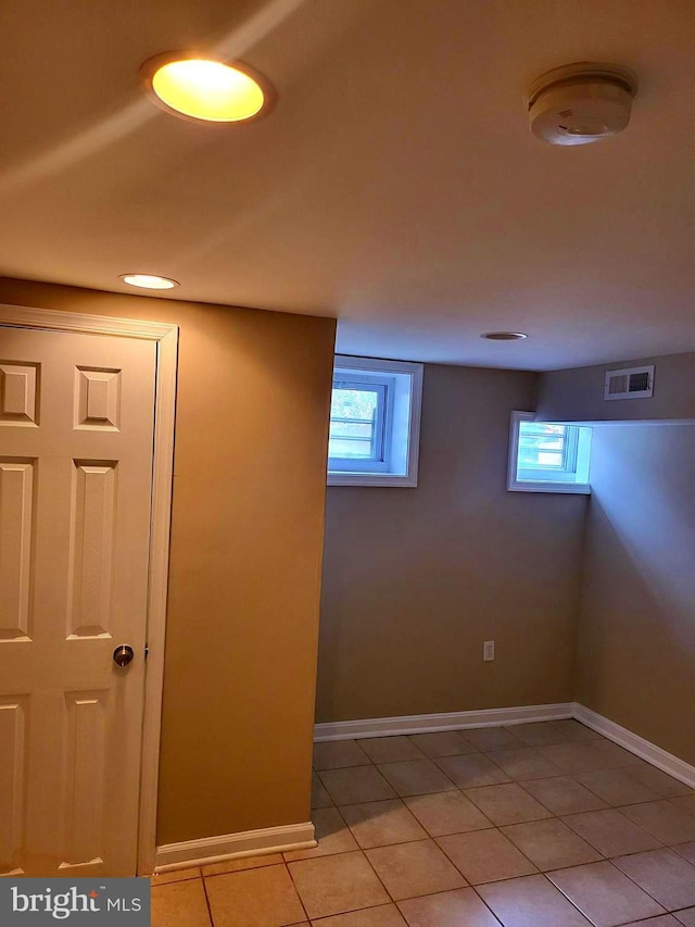 basement featuring light tile patterned floors