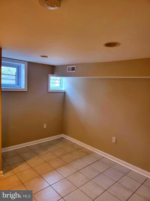 basement featuring a healthy amount of sunlight and light tile patterned floors