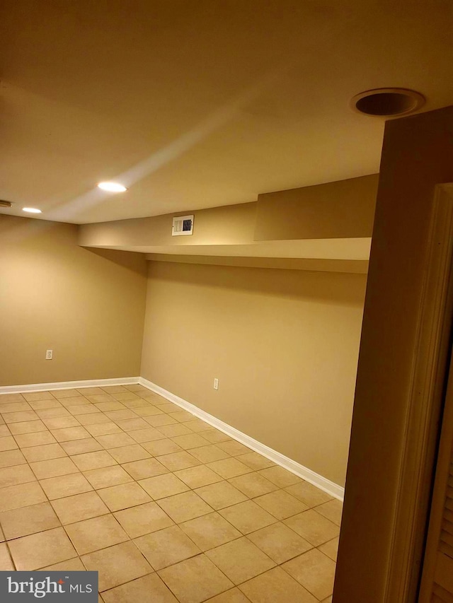 basement featuring light tile patterned flooring