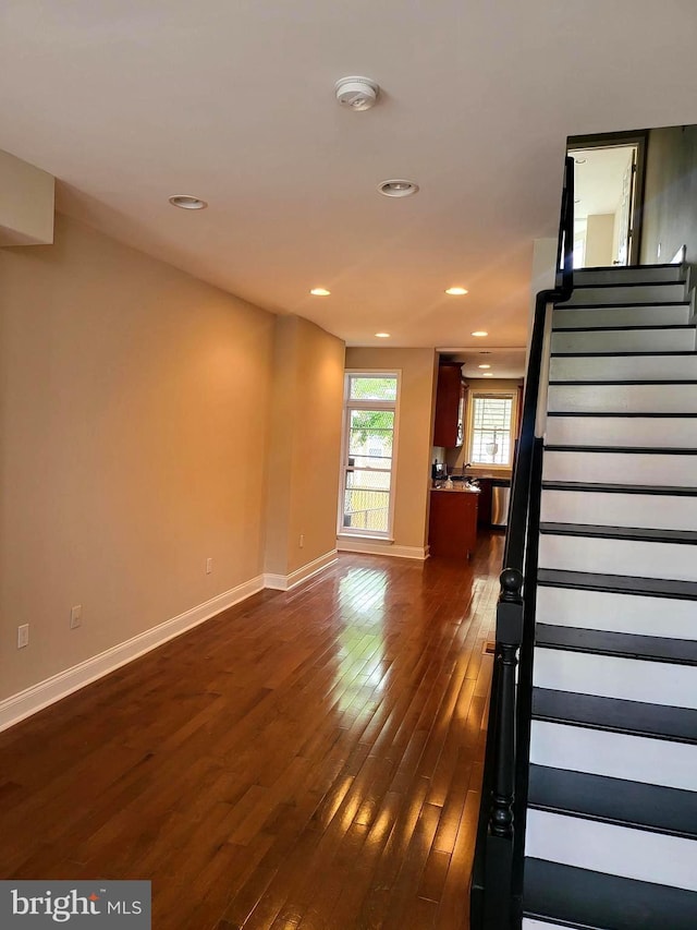 stairway featuring wood-type flooring