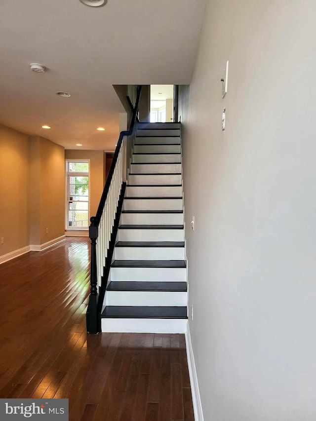 staircase with hardwood / wood-style floors