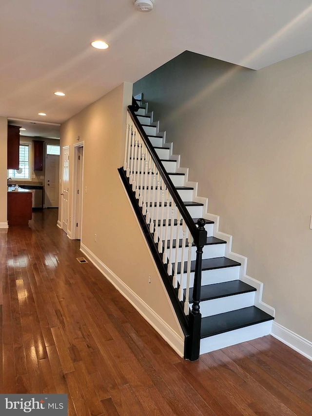 stairway featuring hardwood / wood-style floors