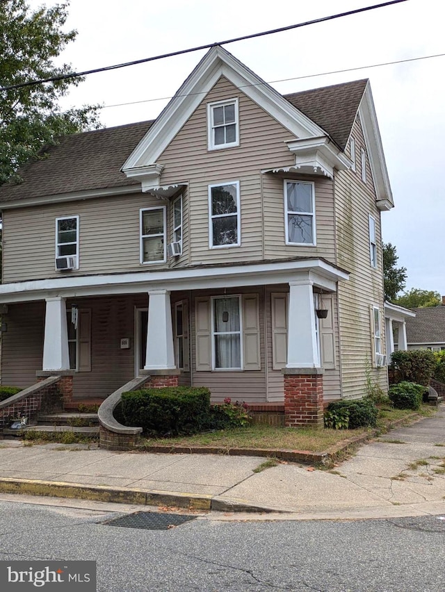 view of front of house with cooling unit and a porch