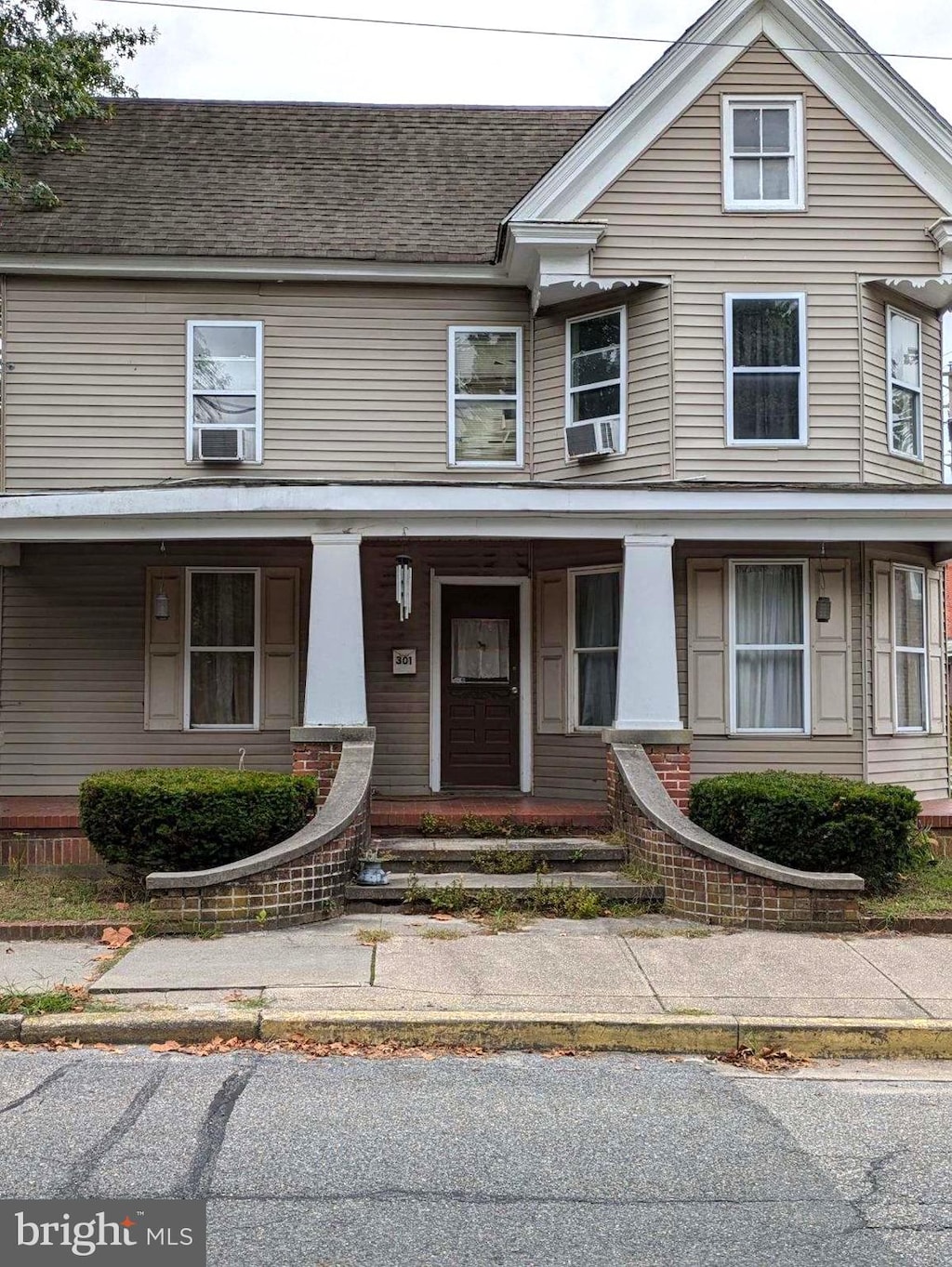 view of front of home with cooling unit and a porch