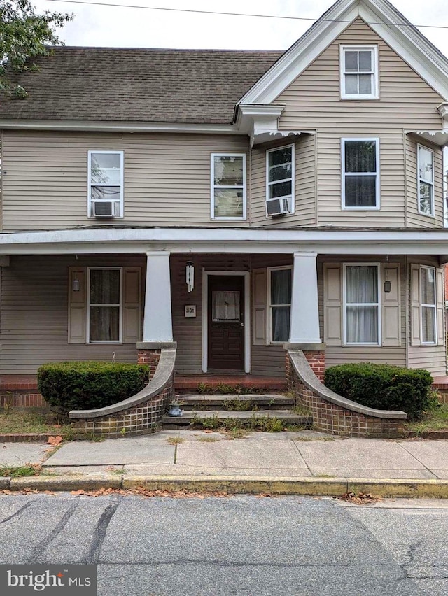 view of front of home with cooling unit and a porch