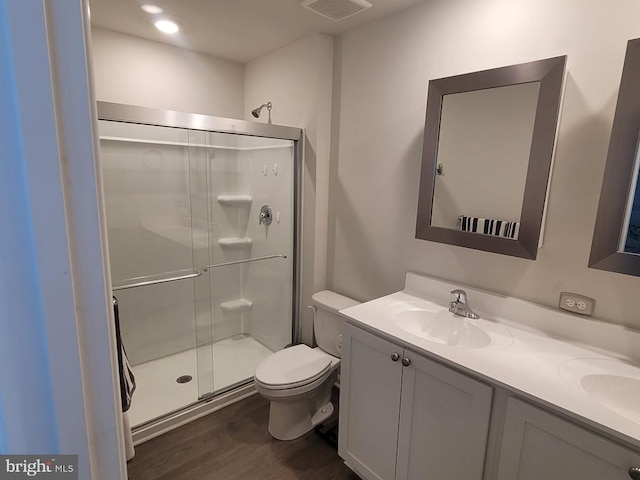 bathroom with vanity, walk in shower, toilet, and wood-type flooring