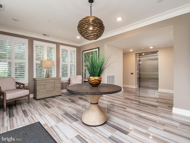 sitting room with light hardwood / wood-style floors, elevator, and crown molding