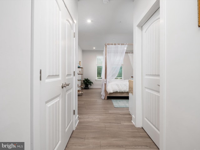 corridor with light hardwood / wood-style flooring