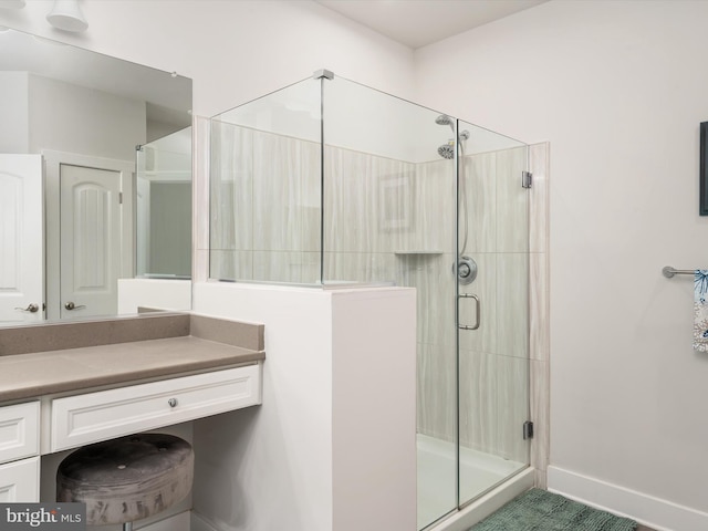 bathroom featuring vanity and a shower with shower door