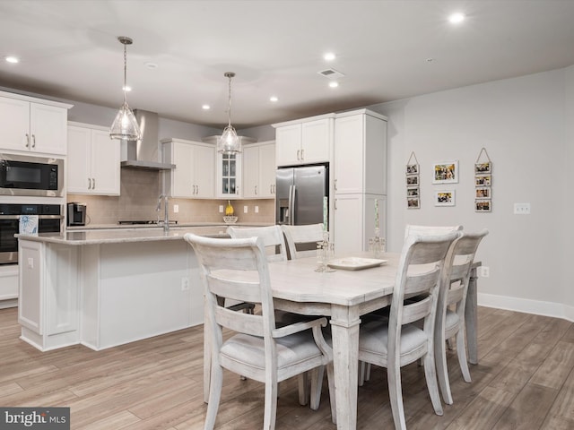 dining space featuring light hardwood / wood-style floors