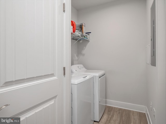 laundry room featuring light hardwood / wood-style floors and washing machine and clothes dryer