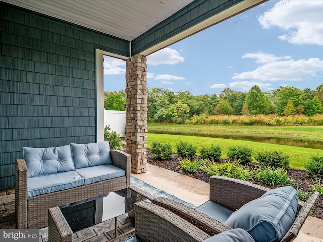 view of patio / terrace featuring a water view and an outdoor living space