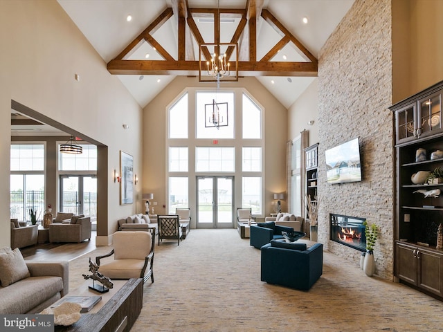 living room with high vaulted ceiling, a fireplace, beamed ceiling, french doors, and a chandelier