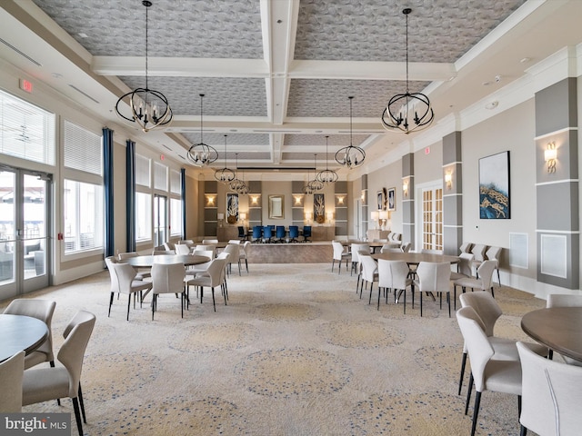 dining space with coffered ceiling, a high ceiling, beam ceiling, ornamental molding, and light colored carpet