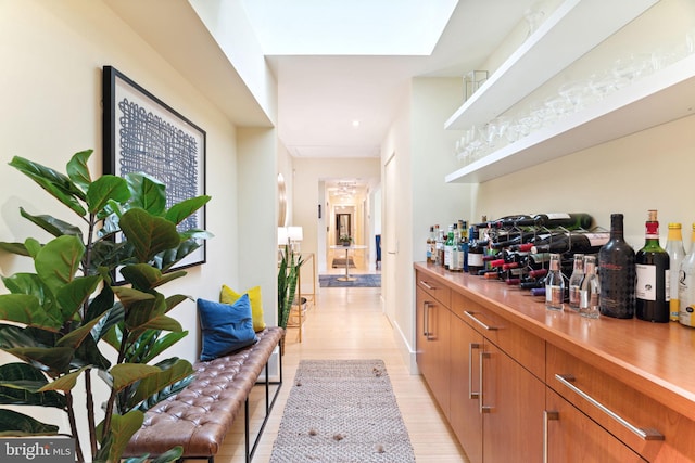 bar featuring light hardwood / wood-style floors