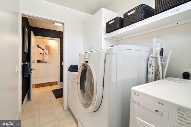 clothes washing area with light tile patterned floors and separate washer and dryer