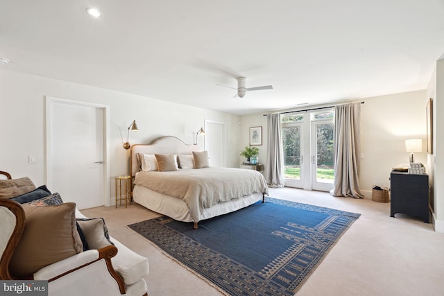 bedroom featuring radiator heating unit, access to exterior, ceiling fan, french doors, and light colored carpet