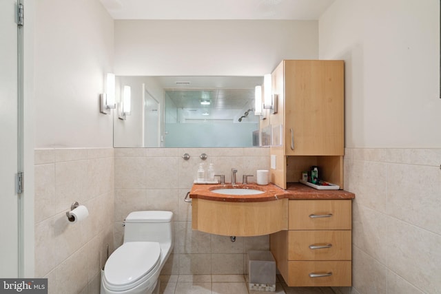 bathroom with tile walls, a shower, and toilet