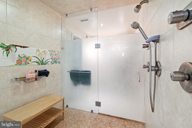 bathroom featuring tile walls and an enclosed shower