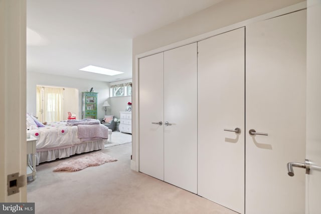 carpeted bedroom featuring a skylight