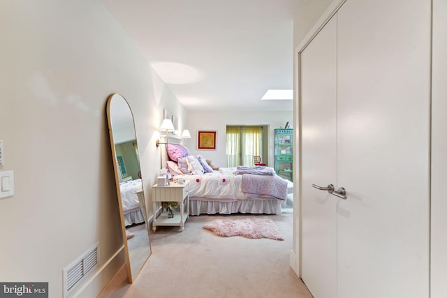 carpeted bedroom featuring a skylight