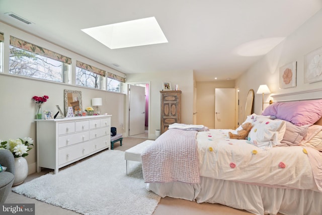 carpeted bedroom featuring a skylight