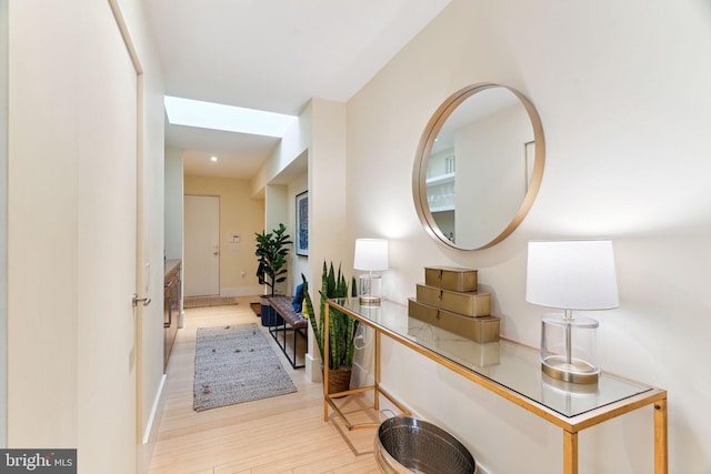 hallway with light hardwood / wood-style flooring