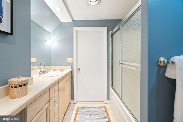 bathroom featuring shower / bath combination with glass door, vanity, and tile patterned flooring