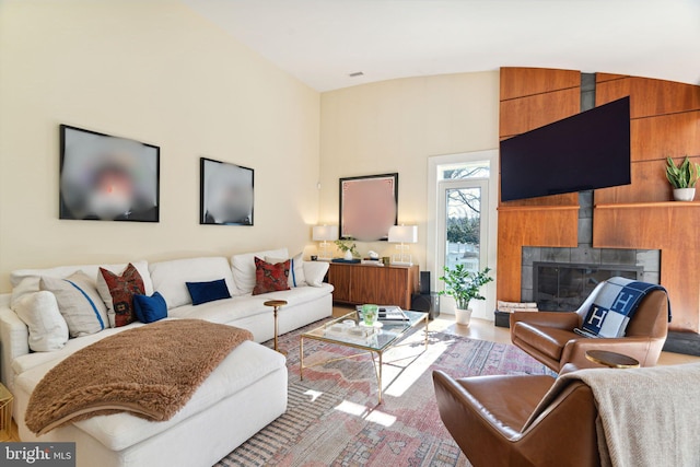 living room featuring wood-type flooring, wood walls, and high vaulted ceiling