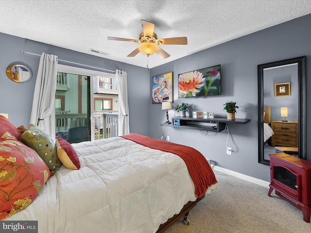 bedroom with ceiling fan, a textured ceiling, and light carpet