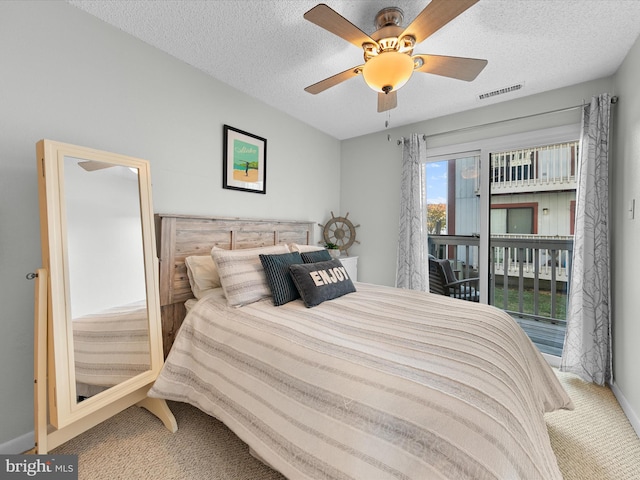 bedroom with ceiling fan, a textured ceiling, and carpet floors