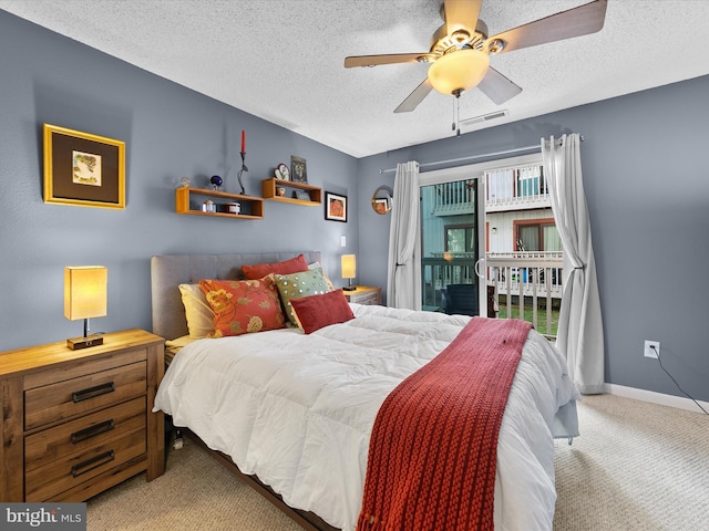 bedroom featuring carpet floors, ceiling fan, and a textured ceiling